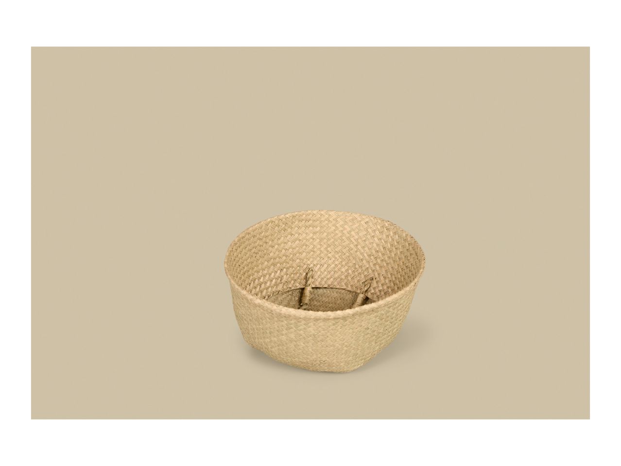 Woven seagrass basket on a light background