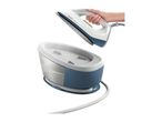 A steam generator iron held by a hand above its water tank.