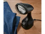 Silvercrest handheld garment steamer with brush attachment next to blue jeans on a wooden surface.