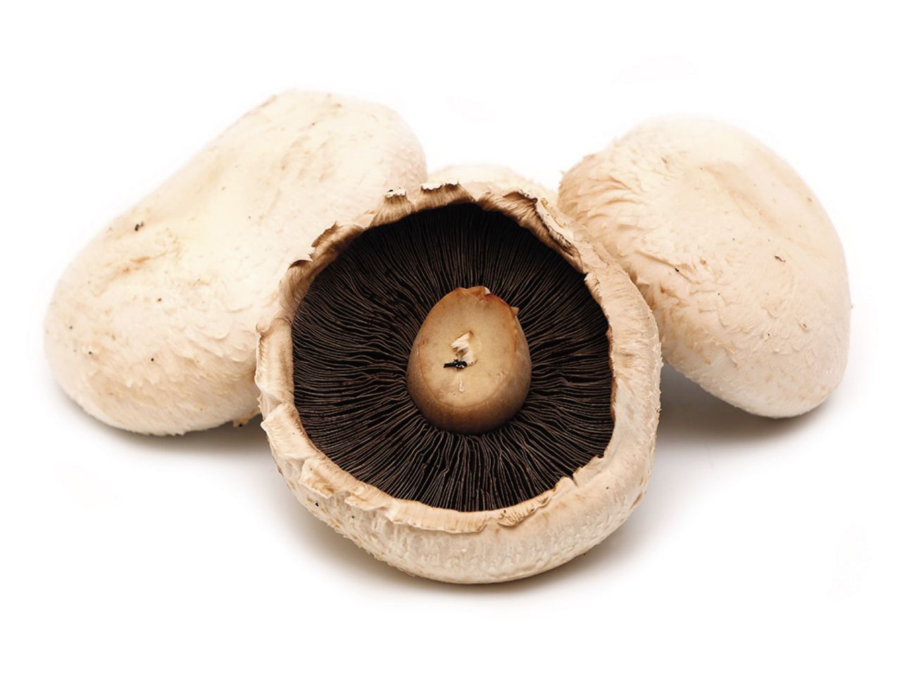 Button mushrooms: three mushrooms, one sliced.