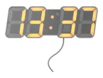 A grey digital clock displaying '09:37' with a visible power cord.