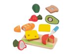 Wooden play food set with bread, cheese, avocado, and other vegetables on a cutting board.