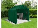 Green tent garage with a grill, folding chairs, boots, and a shovel on a garden patio.