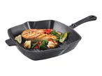 Grilled salmon and vegetables in a black cast iron grill pan.