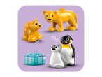 Toy lion and cub, two penguins, and a transparent blue building block on a purple background.