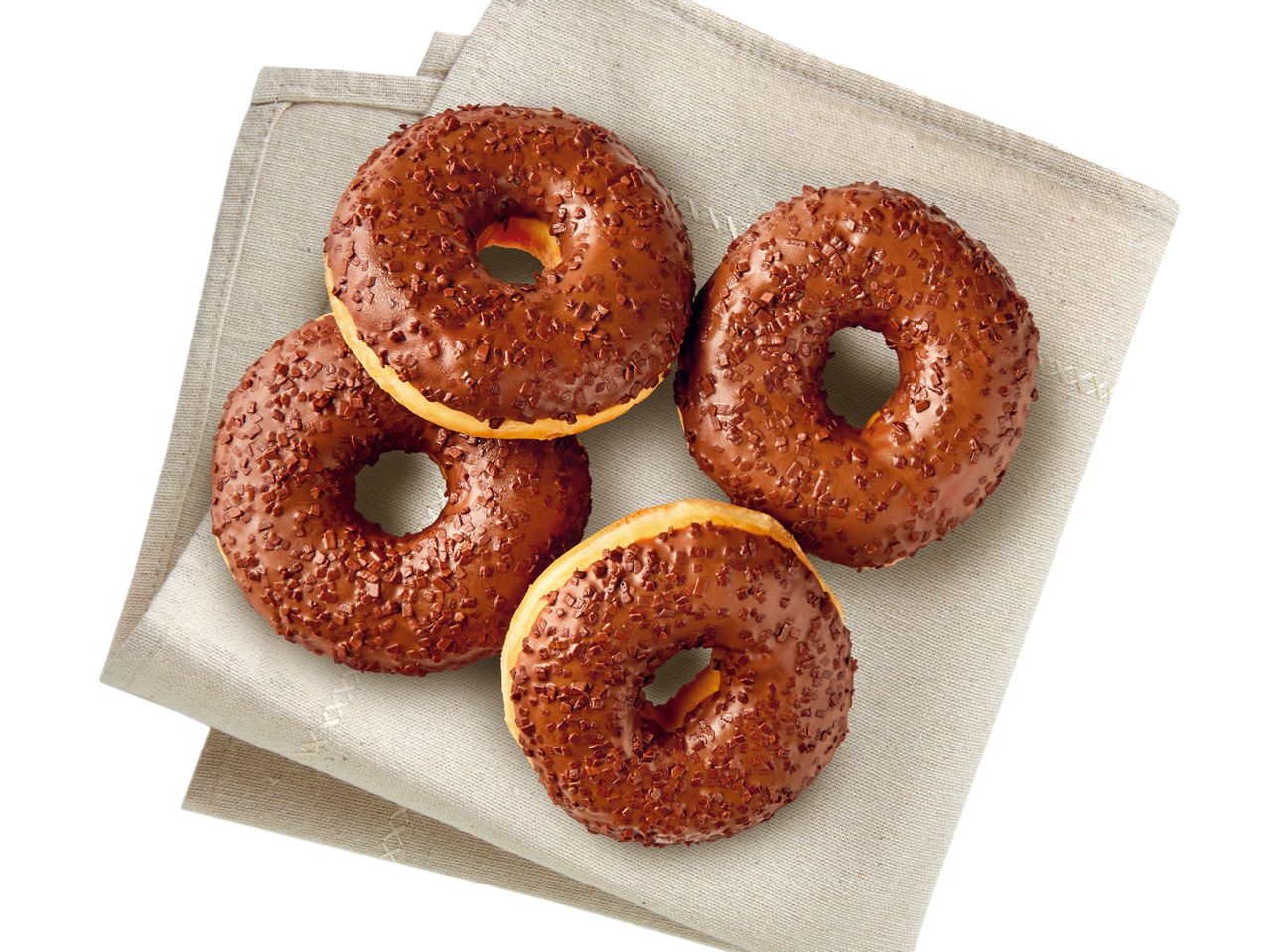 Schokoglasierte Donuts mit bunten Streuseln auf einem Stoffservietten.