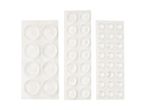Three sheets of clear, circular furniture pads in varying sizes