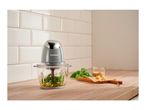 SilverCrest food processor with ingredients for pesto on a wooden counter.