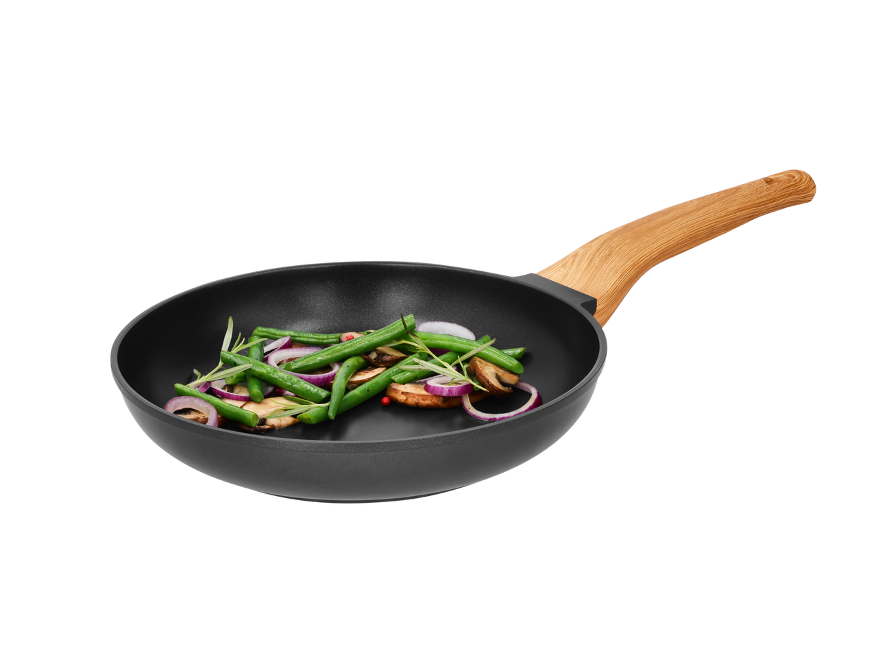 Frying pan with green beans, red onion, and mushrooms on a black background.