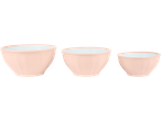 Three pale pink mixing bowls of different sizes with a white interior