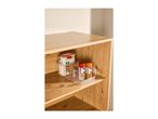 Clear organizer with organic penne pasta and two spice shakers on a wooden shelf.