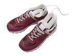 Pair of burgundy sneakers with a shoe dryer inserted in one shoe