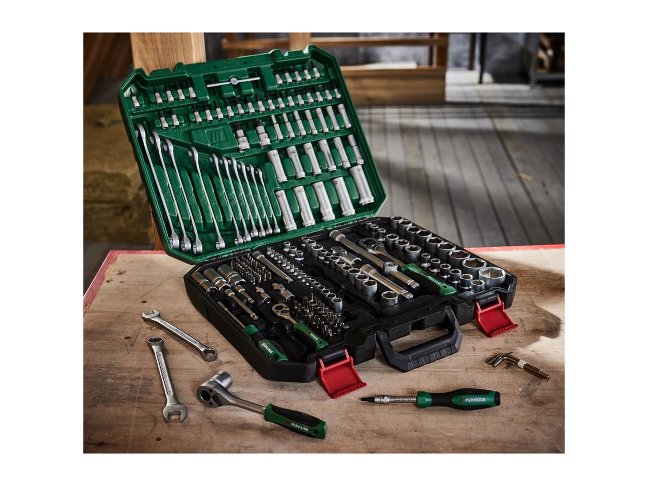 A large Parkside tool set with wrenches, sockets, and screwdrivers on a wooden surface.