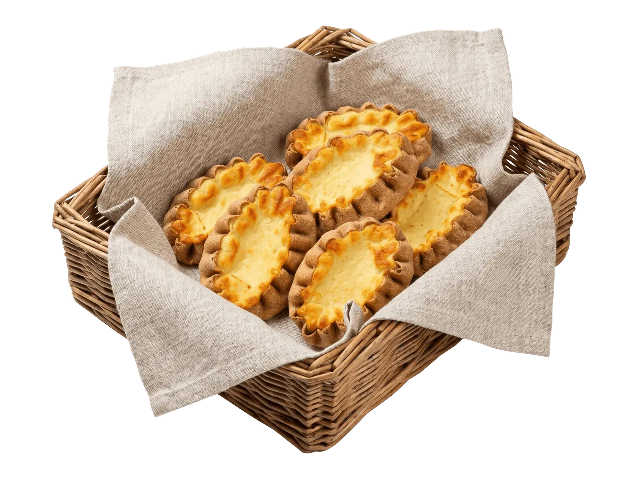 Karjalanpiirakoita korissa pellavaliinan päällä.