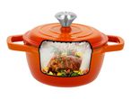 Orange cast iron pot with a cross-section showing a roasted rack of lamb inside.