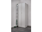 A white storage cabinet and a folded ladder with green accents in a corner.