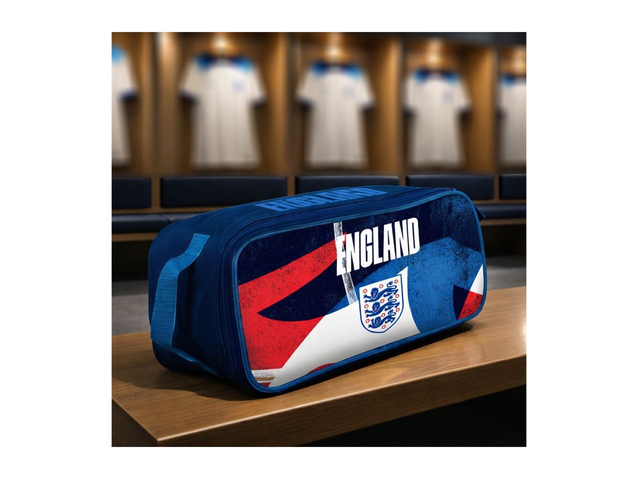 Blue sports bag with 'ENGLAND' text and a crest, on a wooden bench in a locker room.