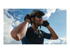 Man in cycling helmet, sunglasses, and gloves against a cloudy sky.