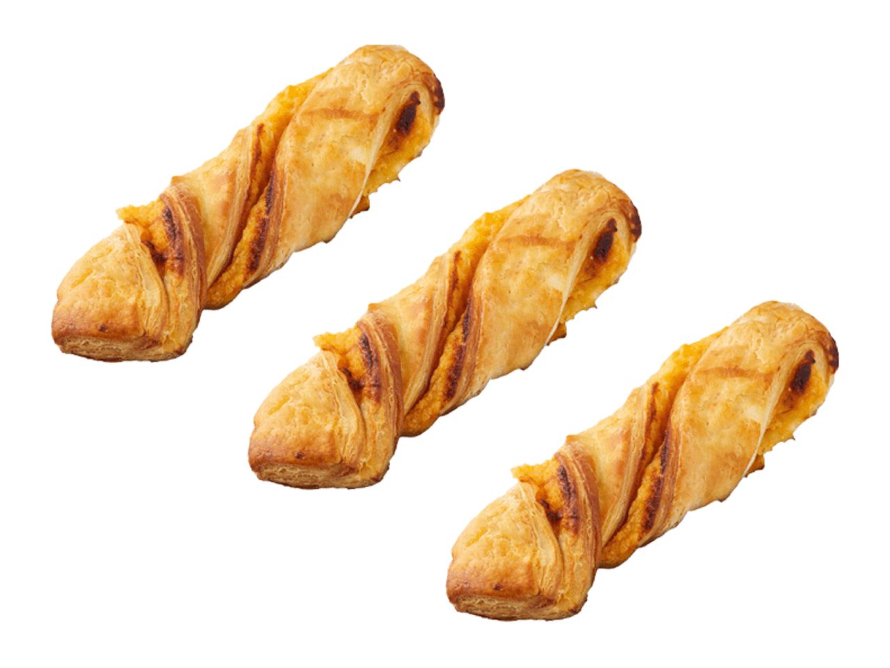 Three golden-brown cheese twists with flaky pastry on a white background.