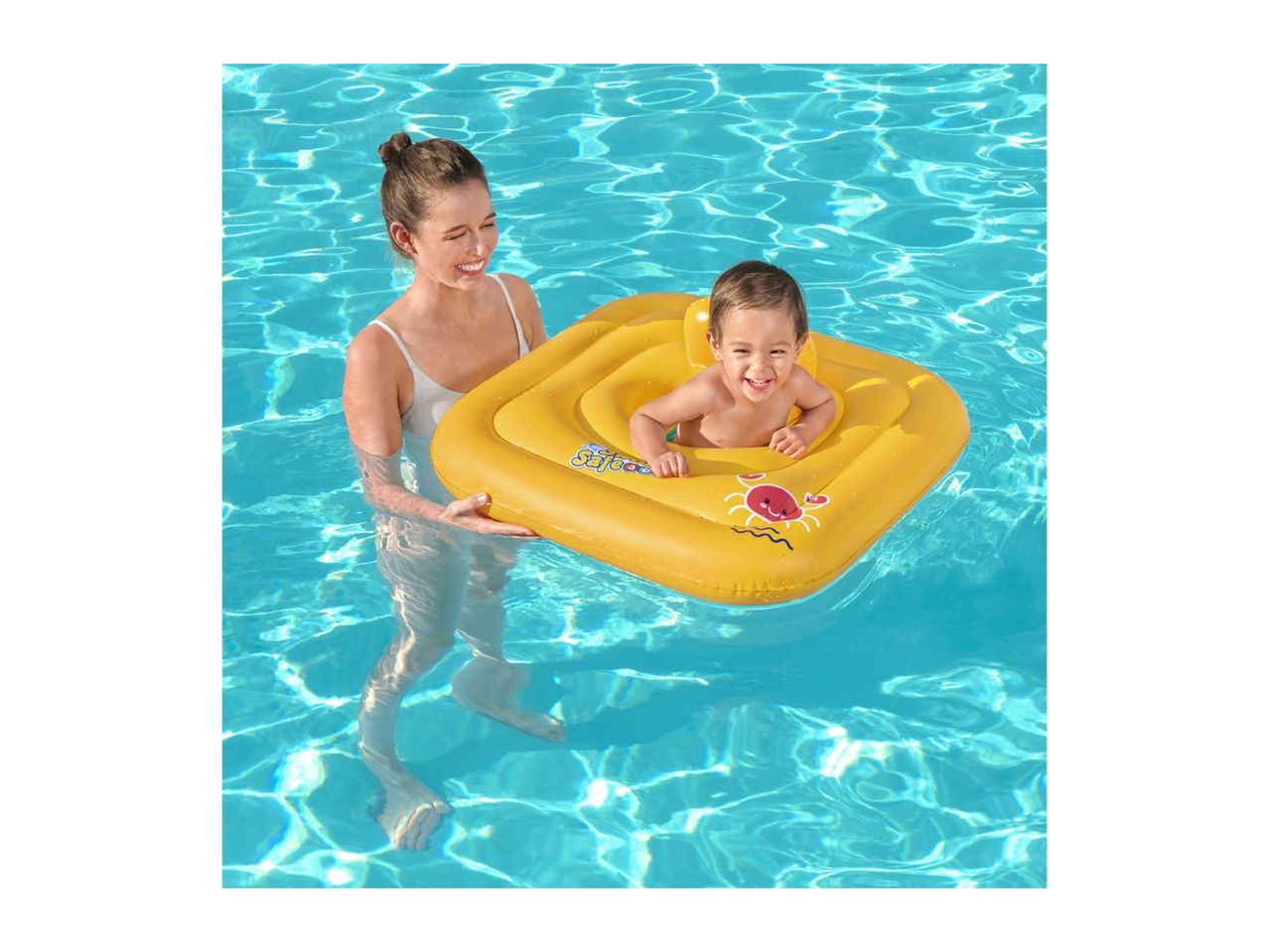 Woman holding a baby in a yellow inflatable baby float in a swimming pool.