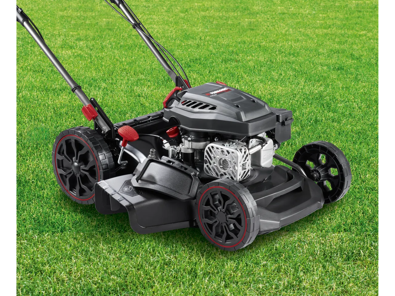 Parkside Performance® petrol lawnmower on green grass.