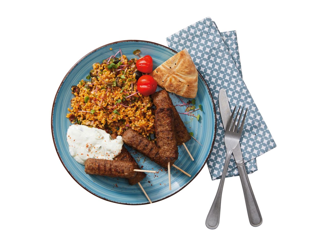 Kebab, bulgur, tzatziki, and pitta bread: a delicious meal.