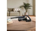 Aspirator de mână SILVERCREST într-un living modern cu cărți pe o masă de lemn.