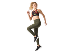 Woman in a black and red sports bra and olive green leggings, running.