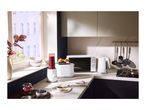 White kitchen appliances including a blender, toaster, microwave, and kettle on a countertop.