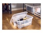 Clear plastic storage boxes with lids, filled with shoes and shoe care accessories.