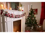 LIVARNO home Wireless LED Christmas Tree Candles on a decorated tree next to a fireplace