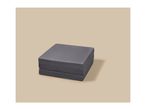 Foldable gray mattress or floor cushion on a light beige background.
