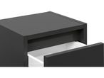 A dark gray bedside table with one drawer slightly open, revealing a white interior.