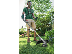 Man using a grass trimmer in a garden, wearing safety glasses and ear protection.