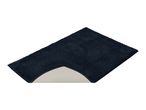 Dark blue bath mat with a cut-out for a toilet, showing the anti-slip backing.
