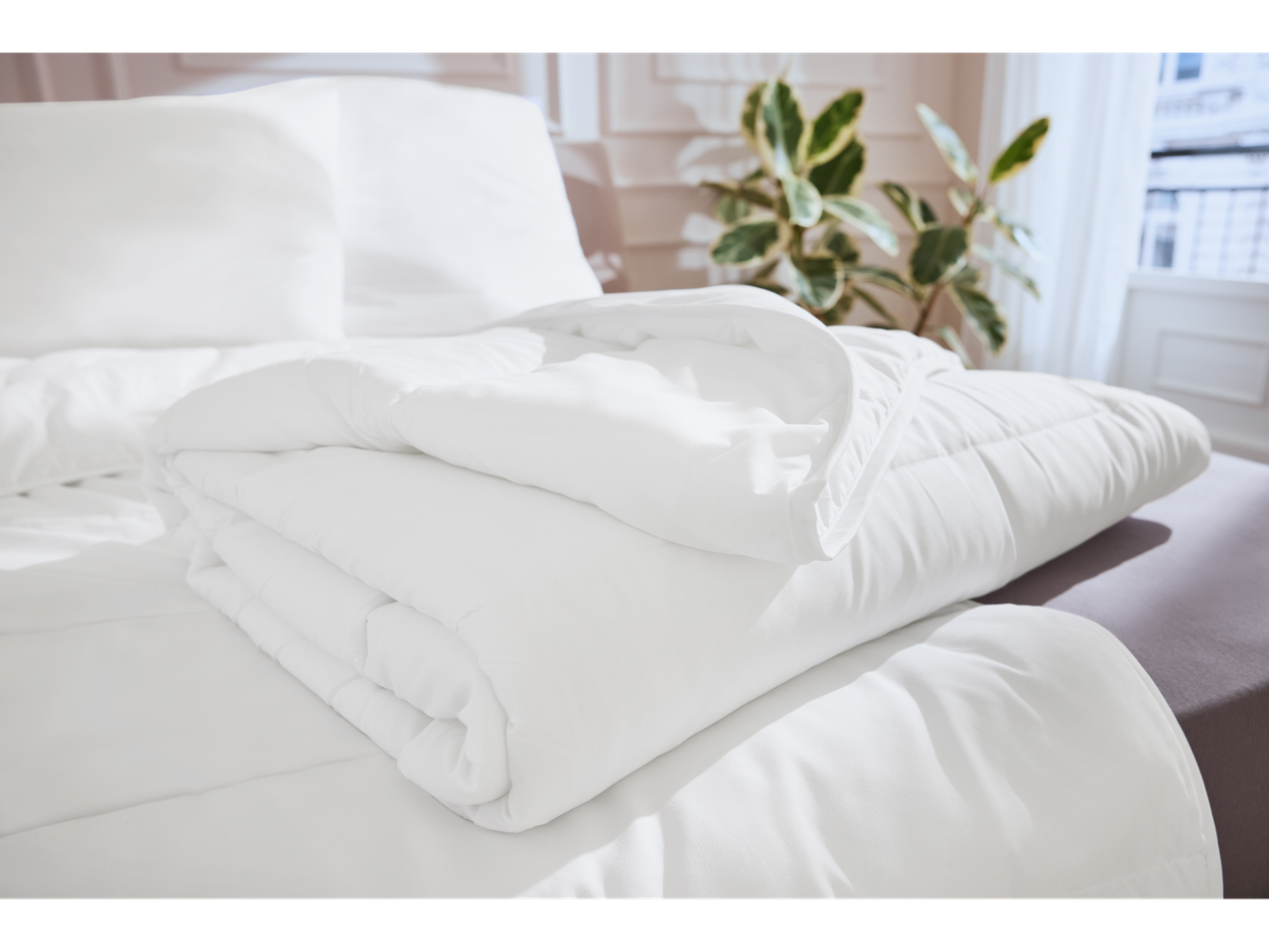 White duvet and sheets on a bed.