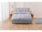 Grey upholstered bed with blue paisley bedding set.