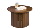 Round wooden coffee table with a book and a decorative jar on top.