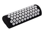 Black acupressure pillow with white spiked discs.