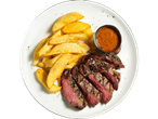 Sliced grilled steak served with potato wedges and a side of sauce.