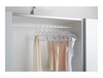 White velvet hangers with various tops and a scarf hanging in a closet.