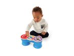 Baby playing with a wooden toy drum set featuring animal designs.