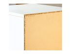 Close-up of a particle board shelf with staples, showing construction details.