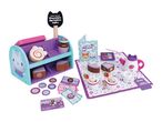 A play set with a cake stand, cakes, tea set, and play money, featuring a 'Chocolate Sprinkles Cake' sign.