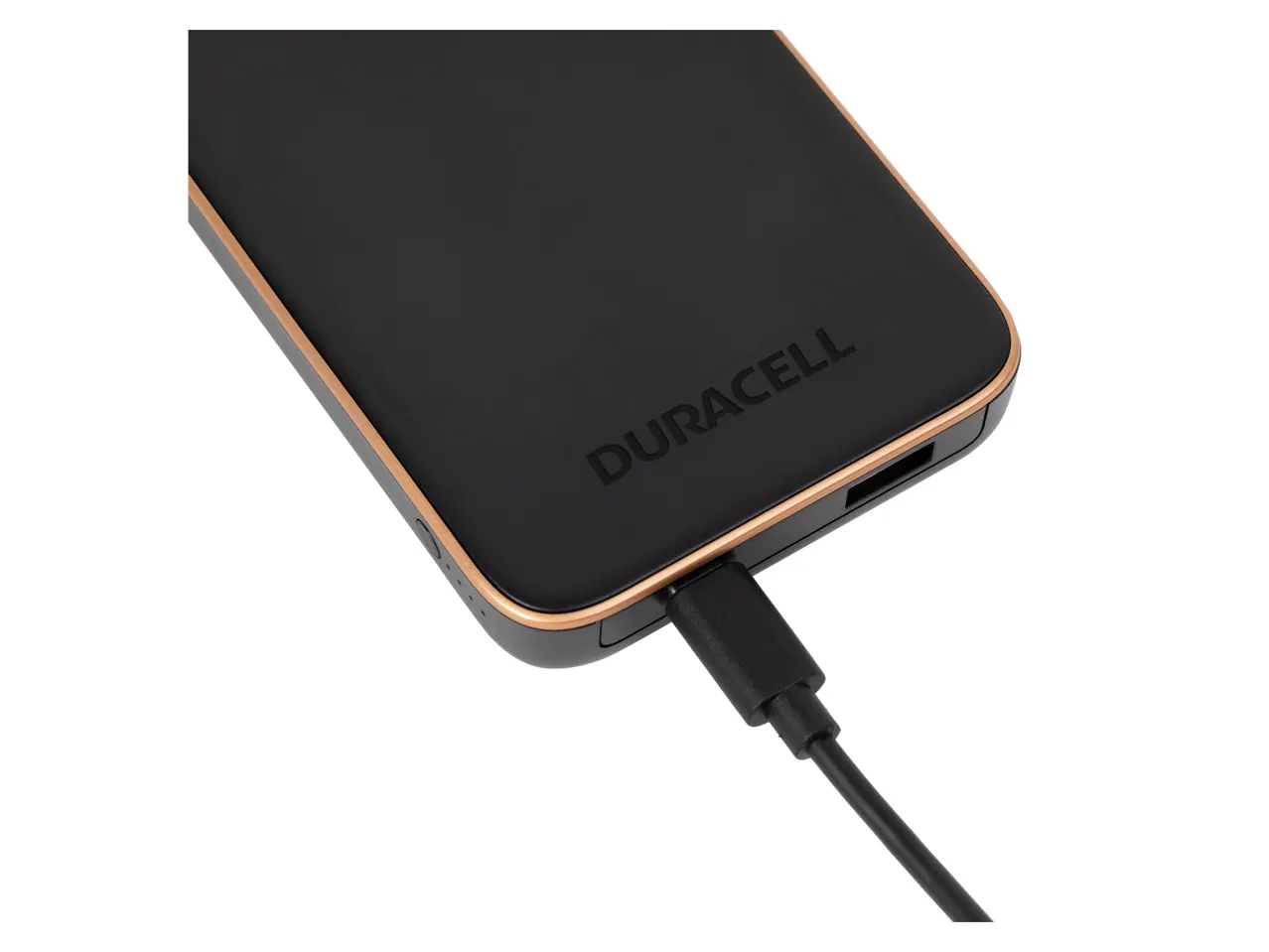 Duracell power bank in black and gold, with a charging cable plugged in.
