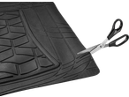 Black rubber car floor mat being trimmed with scissors
