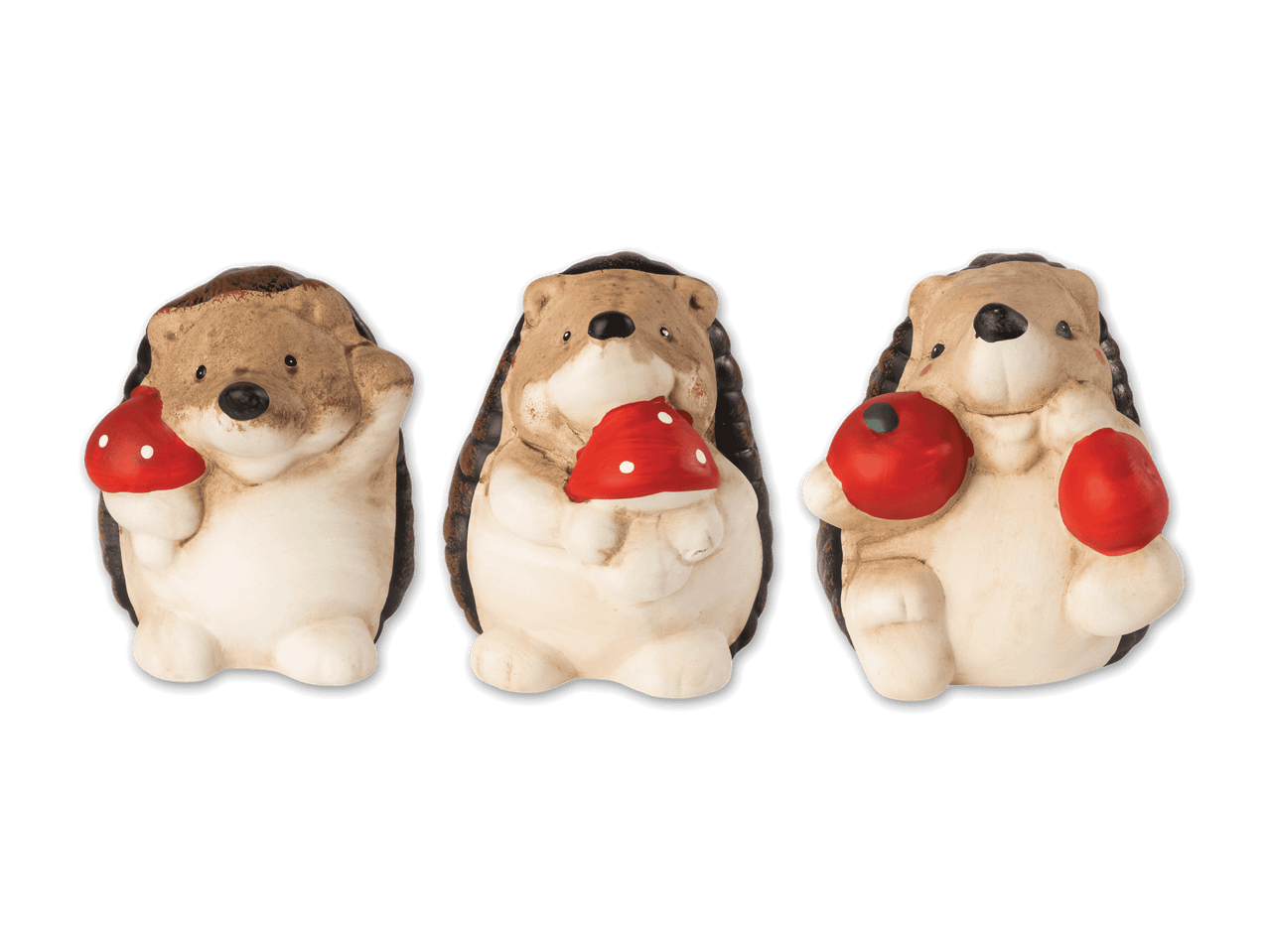 Drei Keramik-Igel-Figuren, die Pilze und Äpfel halten.