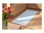 Kitchen runner with blue and white checkered pattern on a wooden floor, next to wooden cabinets.