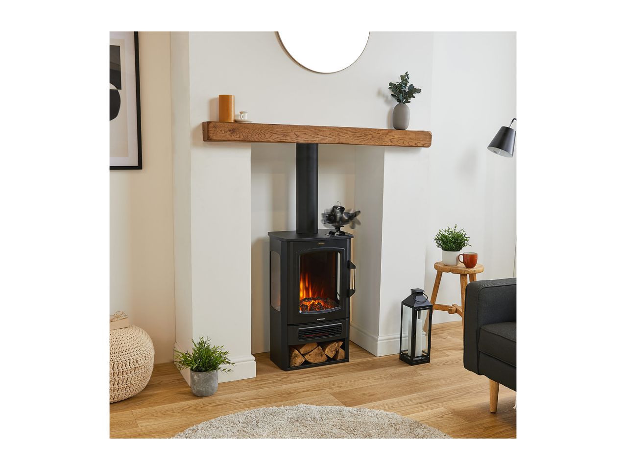 Modern black electric stove heater in a cozy living room fireplace setting.