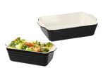 Two black and white rectangular baking dishes, one empty and one filled with vegetables.
